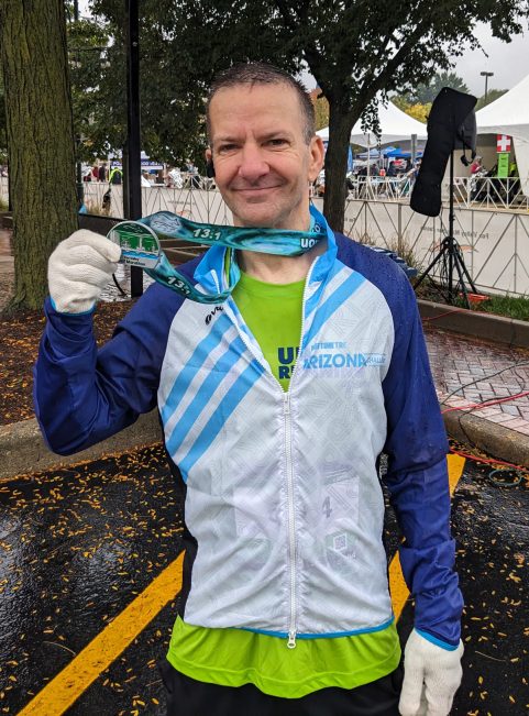 Tom McCall with a half-marathon race medal